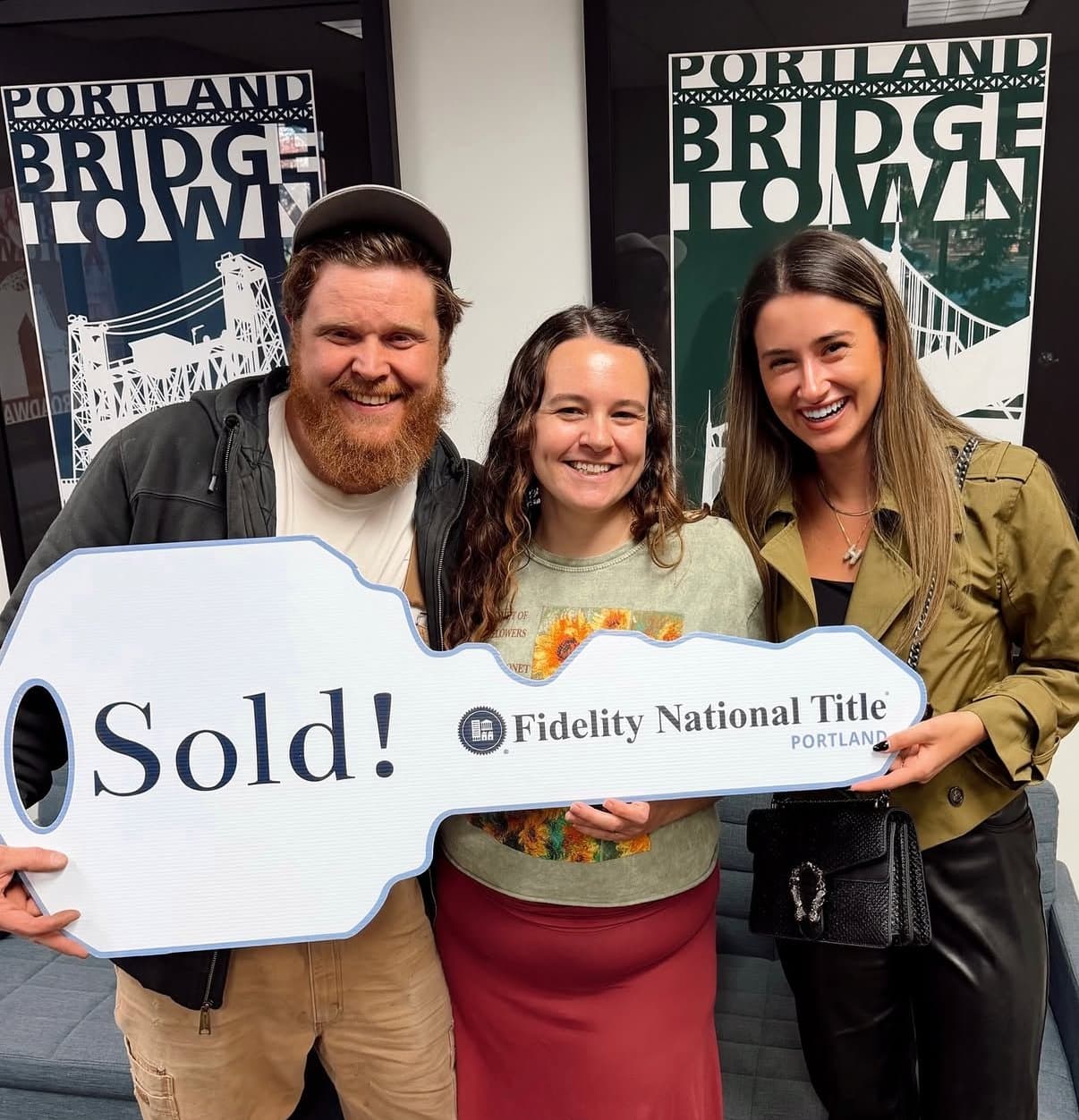 Clients holding Sold sign with Hannah Wolfe in Portland